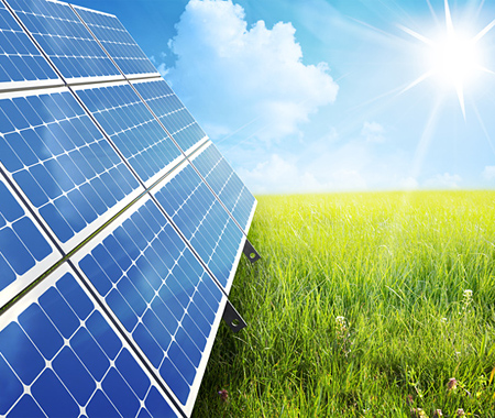 Solarpanels auf grüner Wiese, Sonnenschein und blauer Himmel mit Wolken